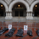 Mock body bags placed by protesters are lined up in front of the Trump International Hotel on April 23, 2020 in Washington, DC.